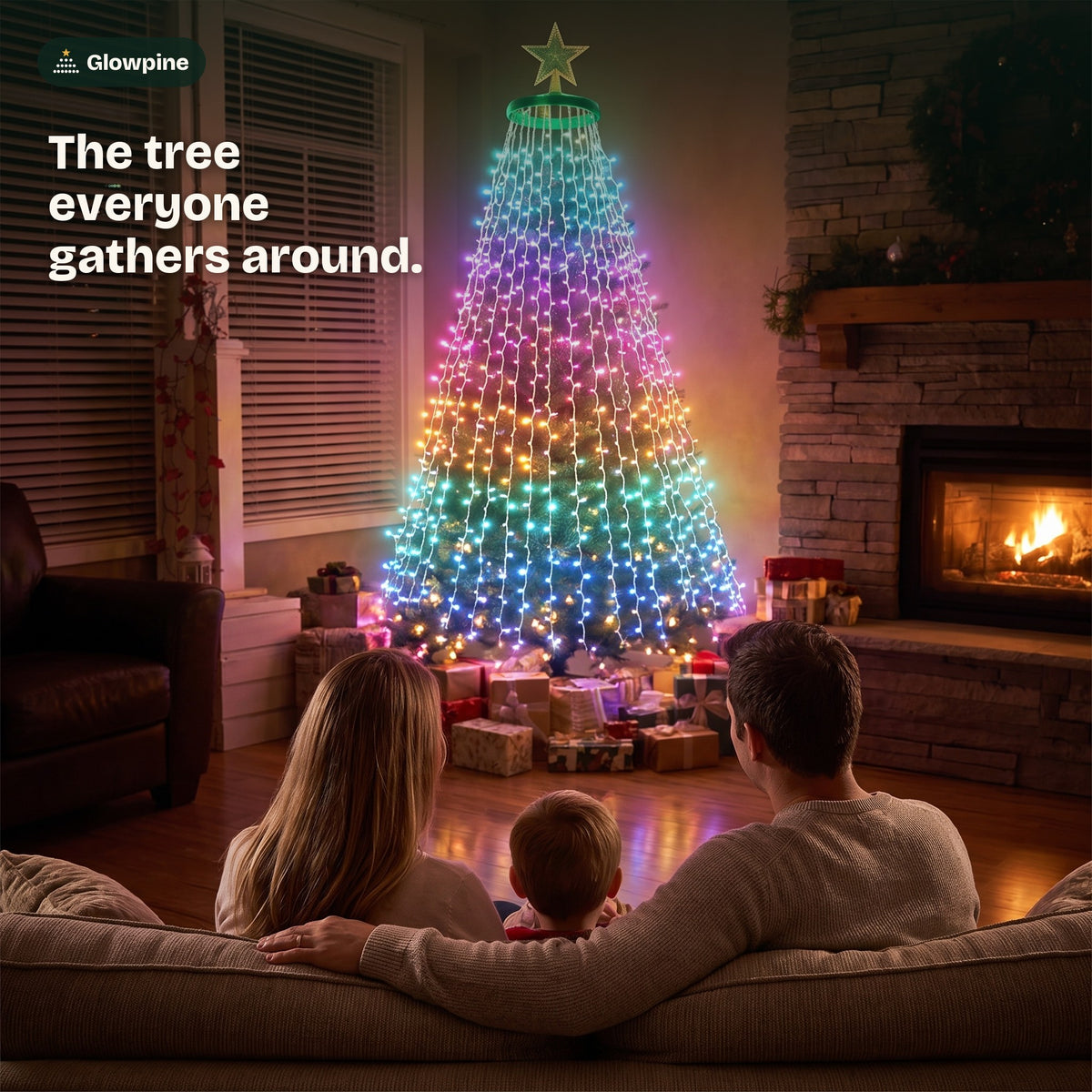 A family on the sofa looking at the lit Christmas tree