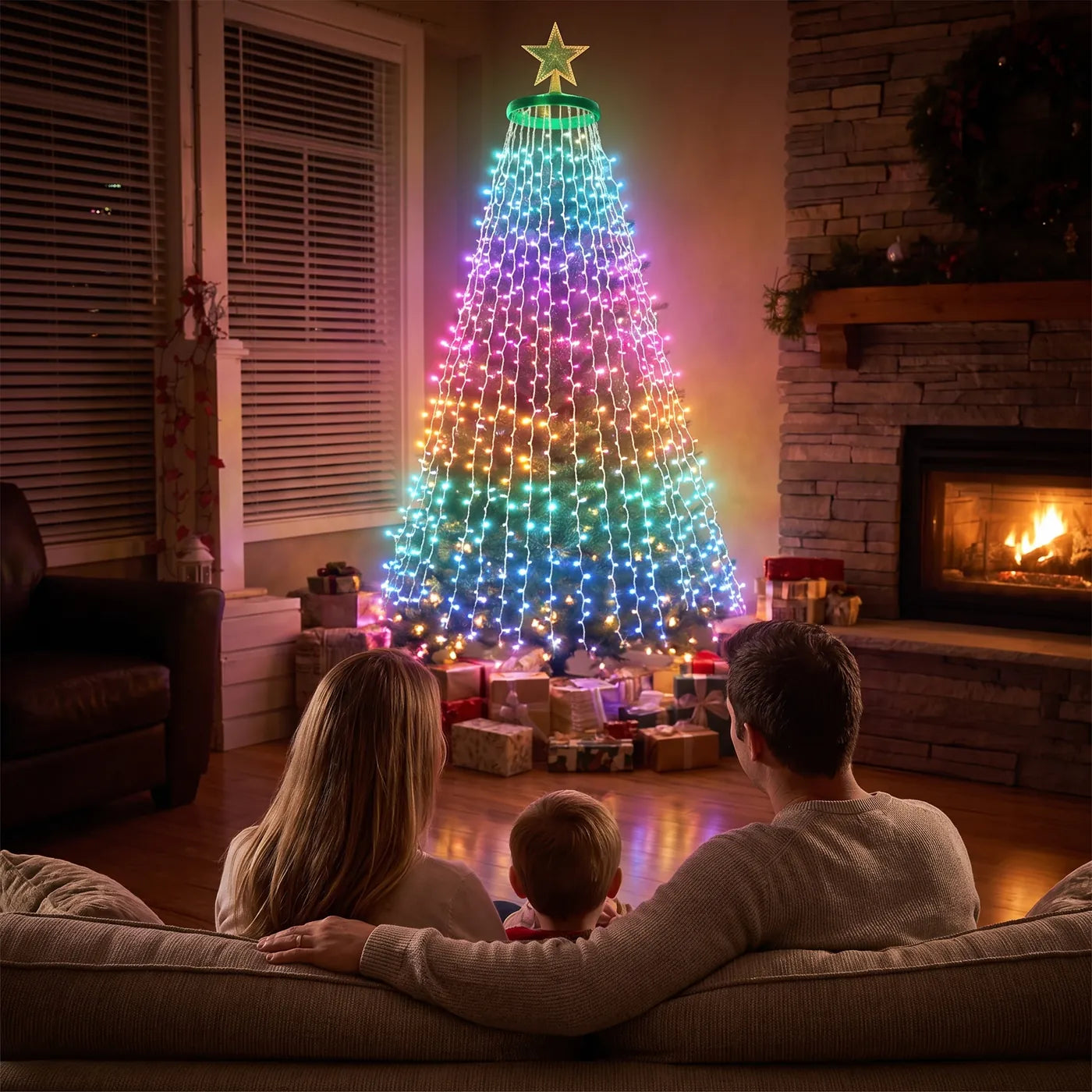 A family on the sofa looking at the lit tree