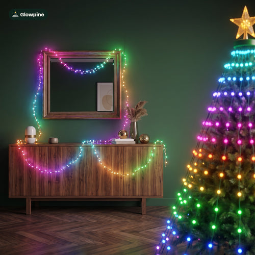 Glowpine Room Lights draped over a mirror and sideboard beside the lit Christmas tree